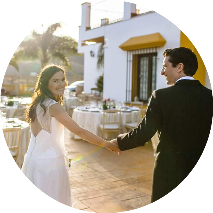 Couple walking while bride looks at the camera